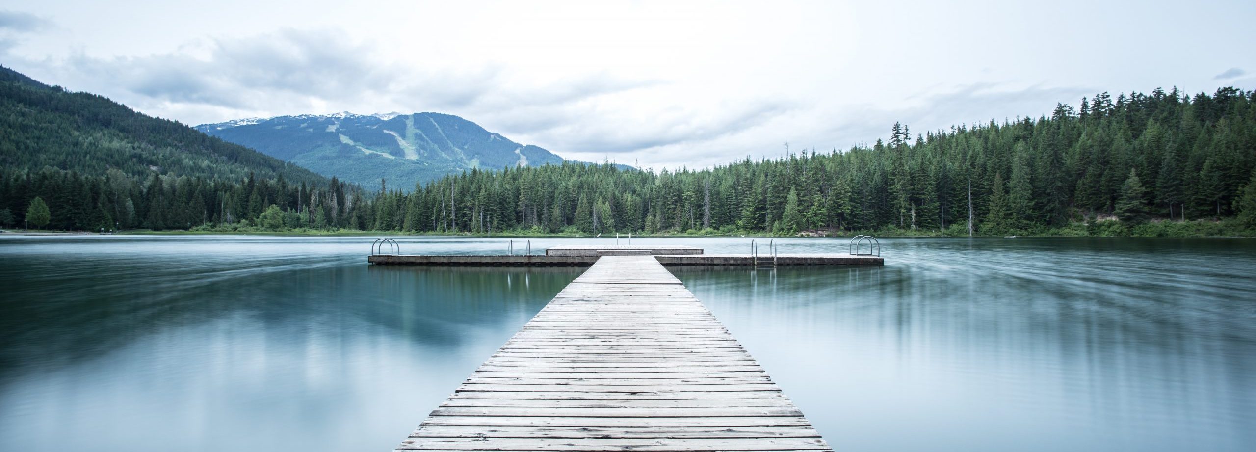 Photo of a long pier on a lake