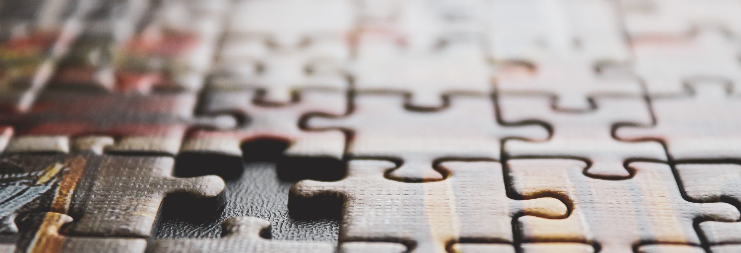 photo of a brown-toned puzzle with a missing piece